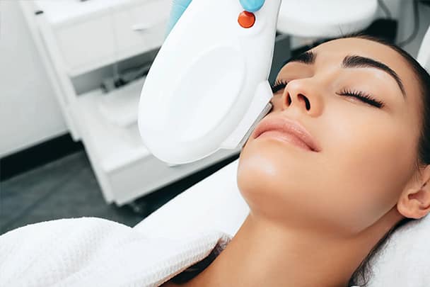 Laser treatment on face of woman in surrey